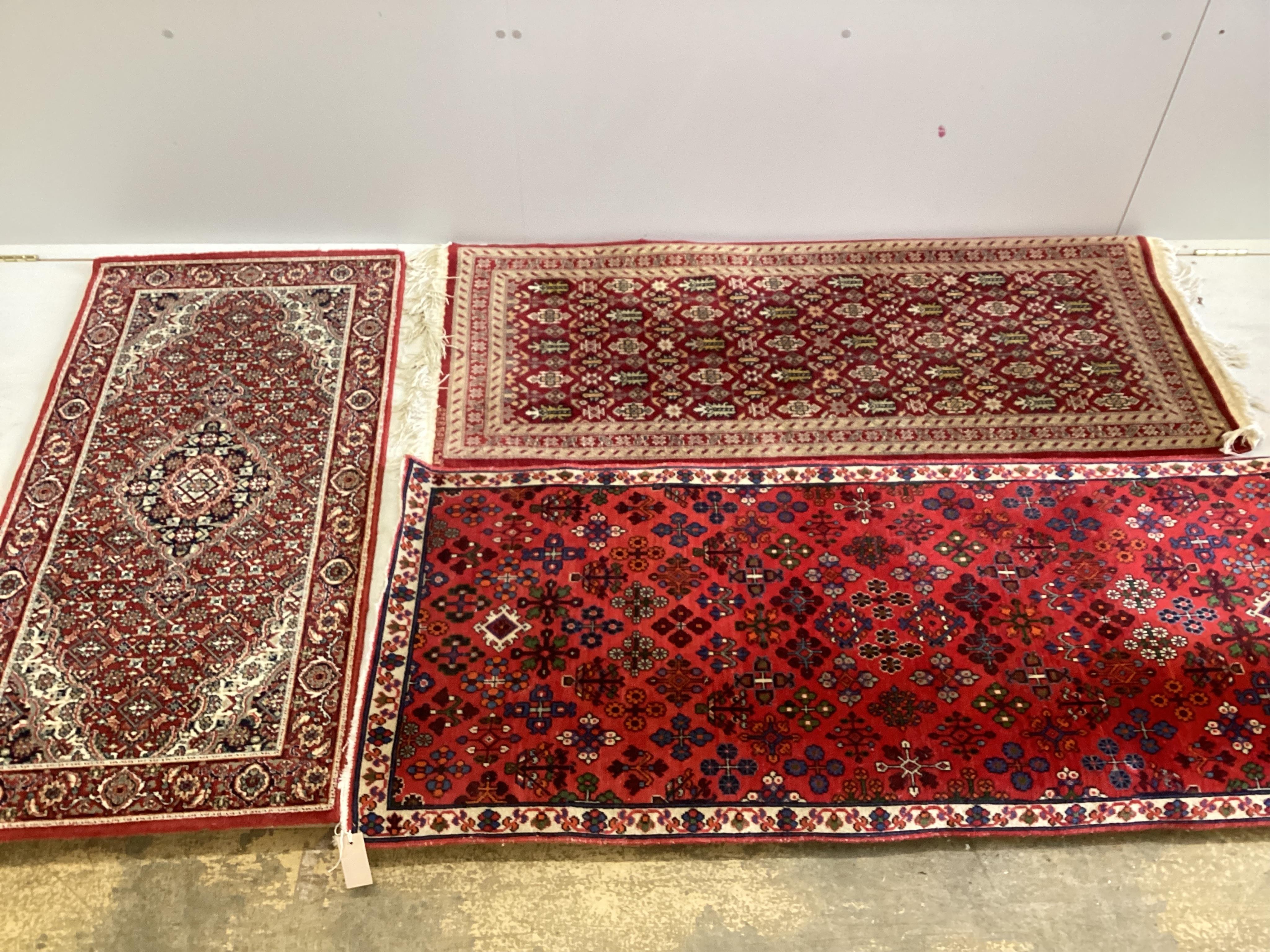 Three North West Persian style rugs, largest 155cm x 66cm. Condition - good